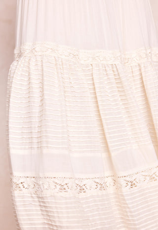 close-up-of-a-cream-colored-sheer-mesh-and-textured-fabric-garment-with-delicate-lace-trim-details