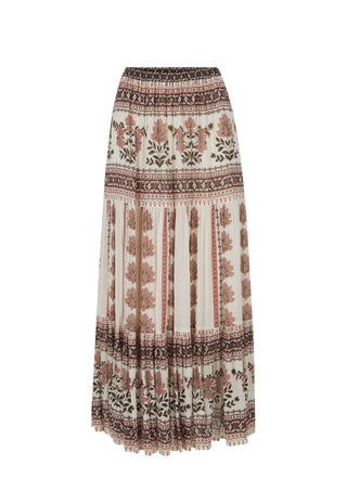 A bohemian-style pleated maxi skirt with a cream base and brown, rust, and black botanical and tribal patterns, shown against a plain white background.