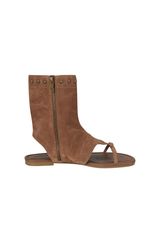 A brown suede ankle sandal with a side zipper, decorative metal studs, and a toe loop, shown from a side profile on a white background.